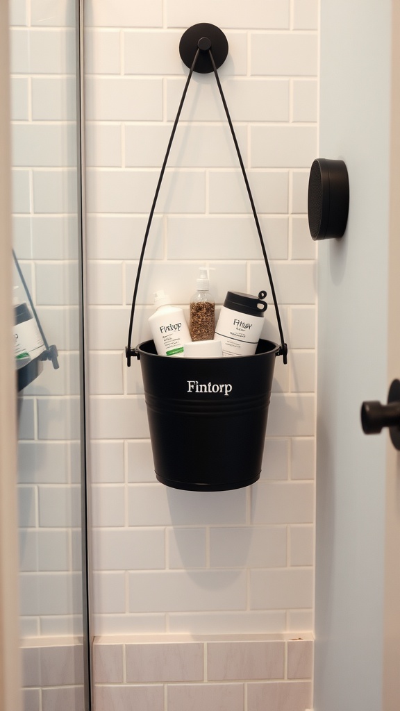 Fintorp bucket mounted on a wall, holding bath products, next to a Bluetooth speaker in a stylish bathroom.