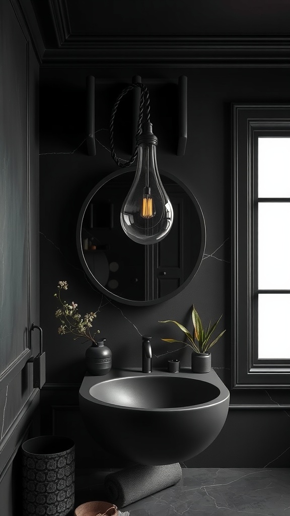 A stylish black bathroom featuring a dark sink, round mirror, and blackened bronze lighting.